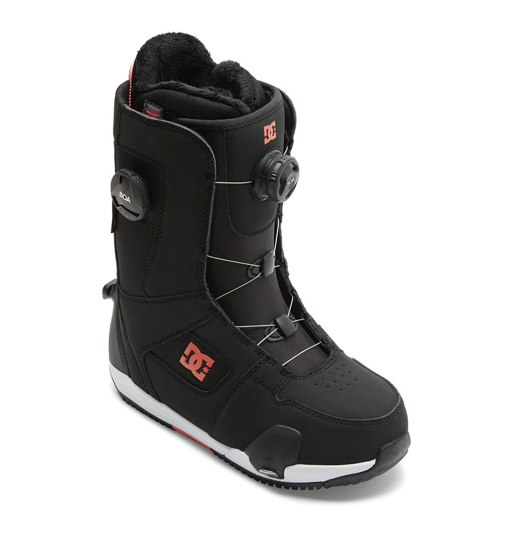 The DC Shoes Women’s Phase BOA® Pro Step On® Snowboard Boot is shown in black with red DC branding, a white sole, and features the Dual Zone BOA® Fit System dial lacing system, displayed on a white background.
