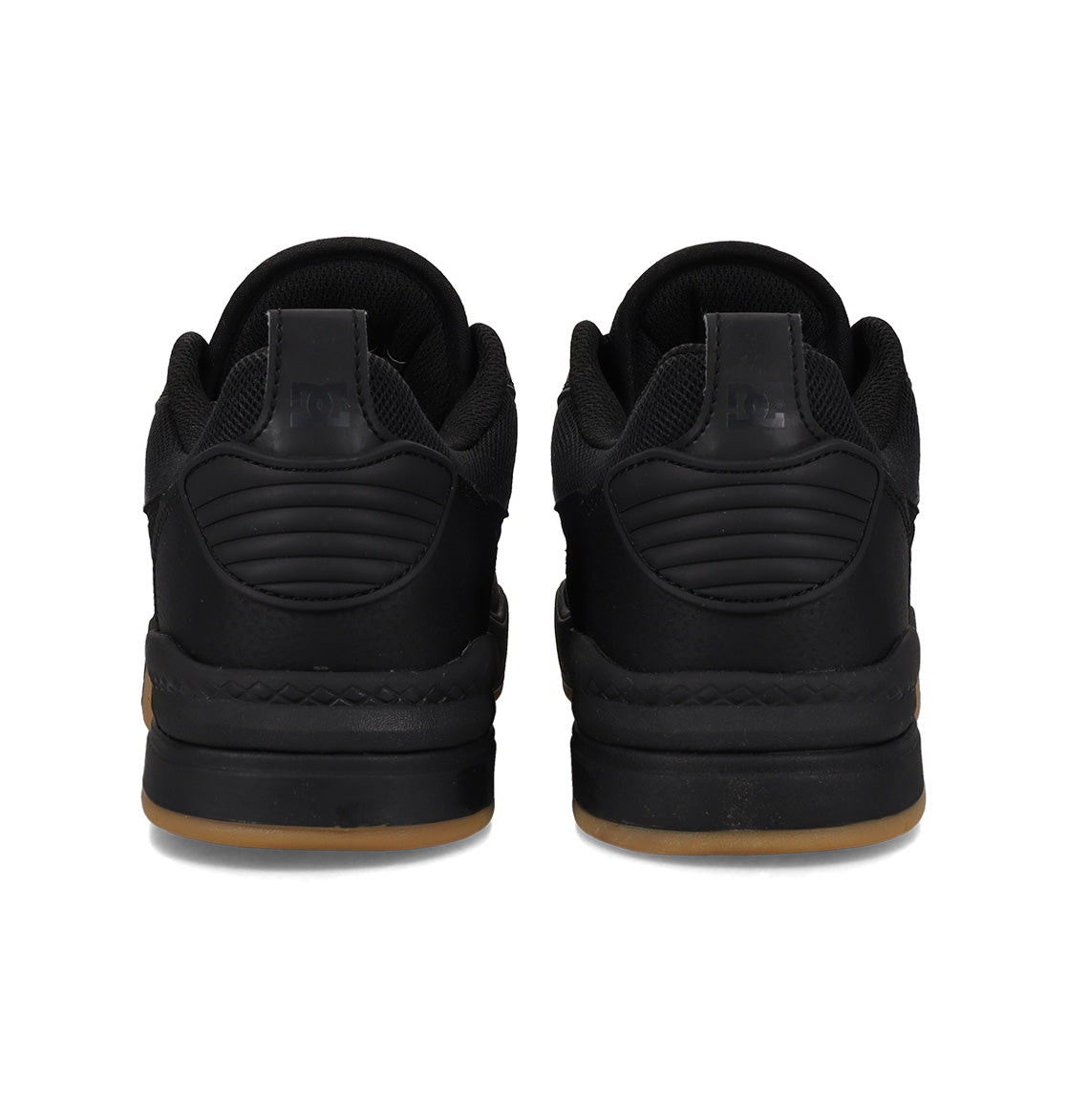 A pair of black DC Shoes Men’s Ascend Skate Shoes viewed from the back, featuring thick soles with a light brown gum base, quilted heel detailing, and black laces—these sneakers seamlessly blend modern comfort with timeless style.