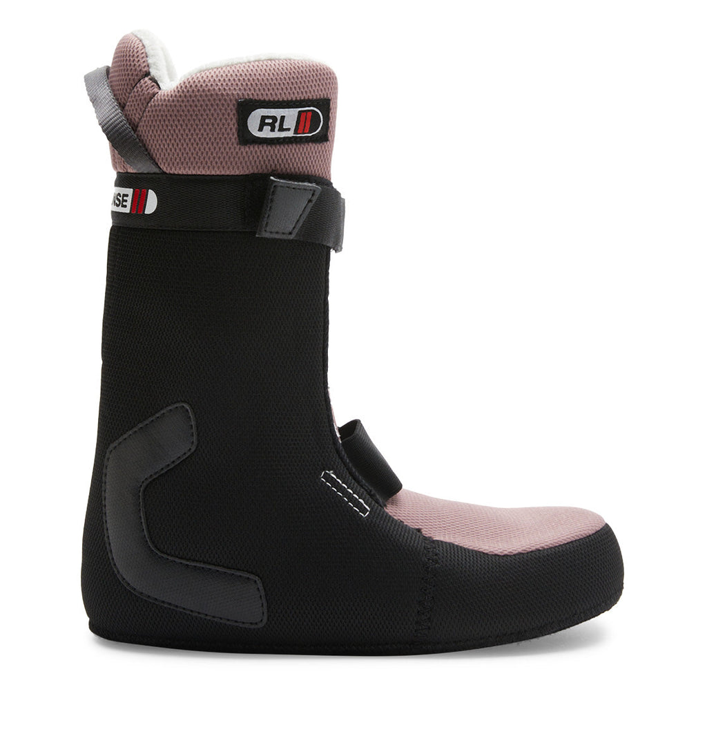 The DC Shoes Women’s Lotus Step On® Snowboard Boot is shown in a side profile against a white background, featuring a black and pink boot liner with a Velcro strap at the top, rubber support patches, and visible stitching.