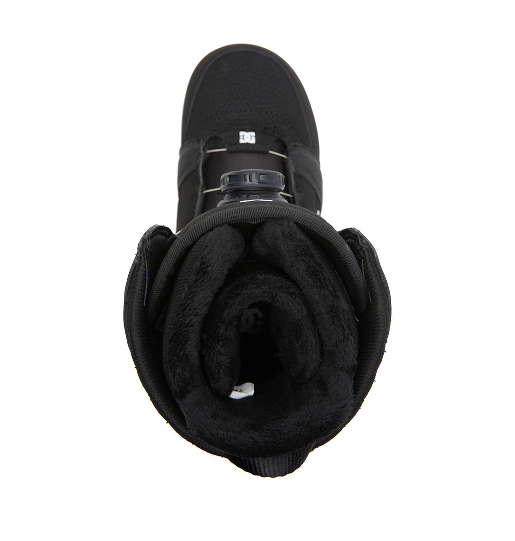 Top view of the DC Shoes Women’s Lotus BOA® Snowboard Boots in black, showcasing a plush fur-lined interior, advanced BOA® Fit System lacing, and a prominent DC logo on the tongue. The design is finished with a lightweight Unilite outsole that offers superior comfort and performance.