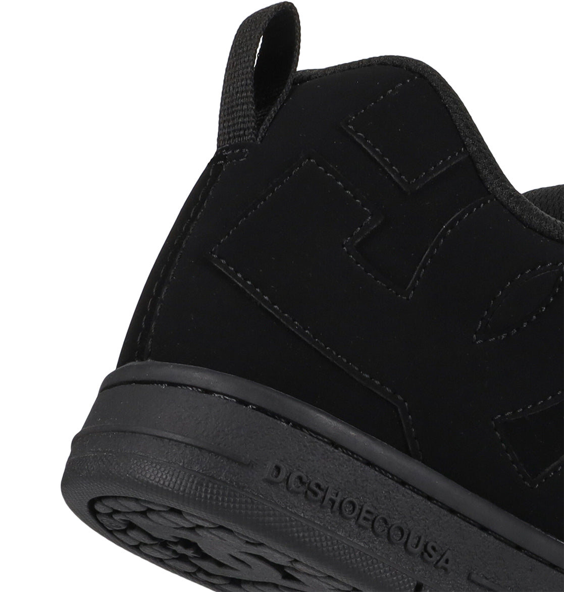 Close-up of a black sneaker with visible branding on a white background