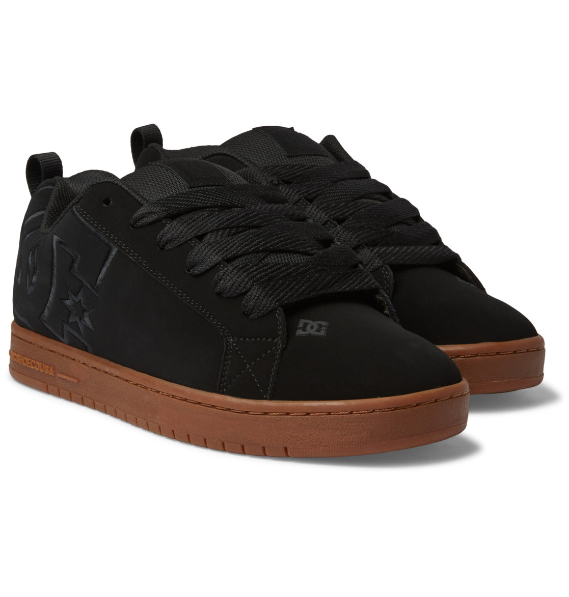 A pair of DC Shoes Men’s Court Graffik Shoes in black, featuring thick black laces, signature black DC logo details, brown rubber soles, and the classic puffy silhouette, displayed on a white background.
