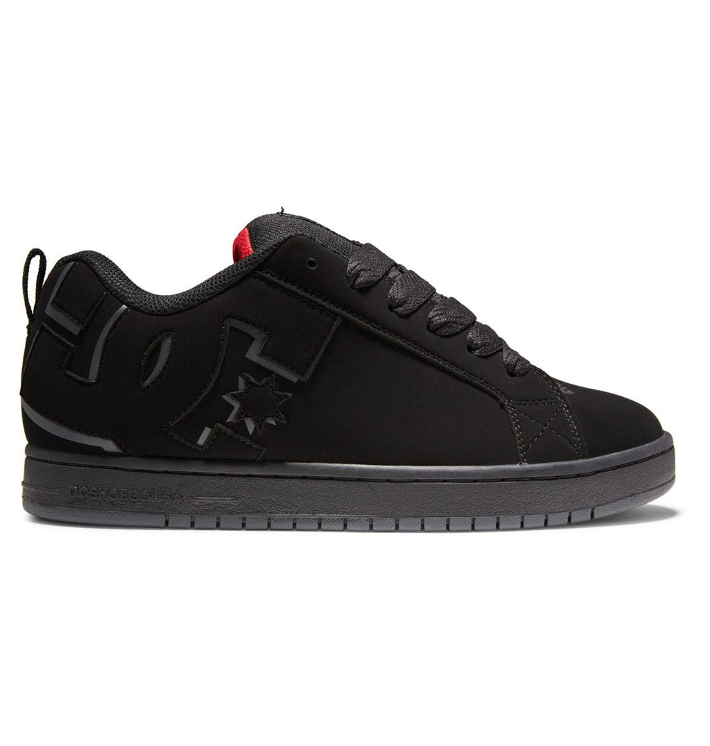 The DC Shoes Men’s Court Graffik Shoes feature a black low-top silhouette with a thick sole, lace-up closure, and subtle DC logo detailing on the side. Designed with a small red accent on the tongue, these sneakers offer a sleek, minimalist appearance along with a slightly puffy build for enhanced comfort and street-inspired style.