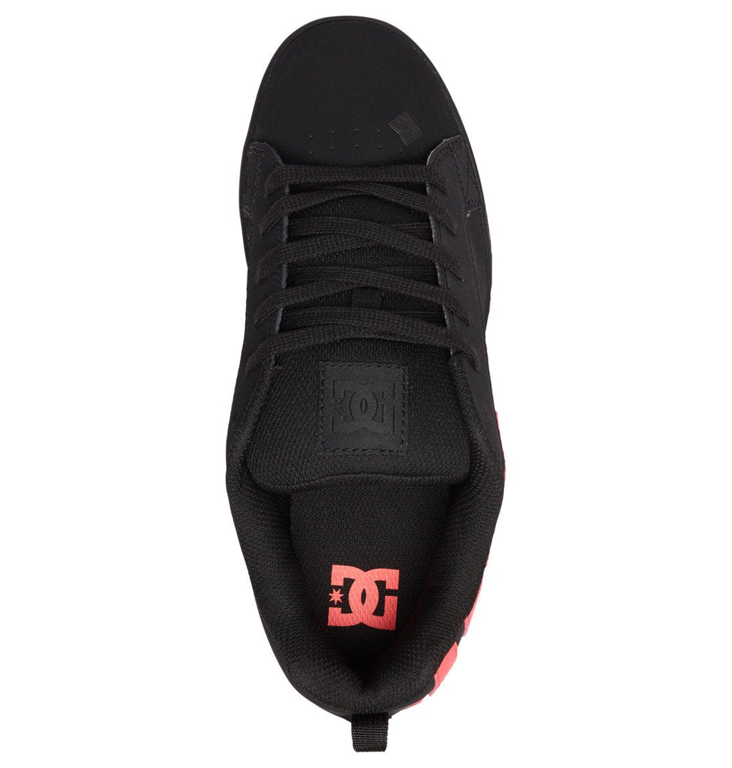 Top view of the DC Shoes Women’s Court Graffik Shoes in black, featuring chunky styling with black laces, a black tongue adorned with a stitched logo, and a striking red DC logo on the black insole. This women’s sneaker boasts a rounded toe and padded collar, seamlessly blending ’90s-inspired design with contemporary comfort.