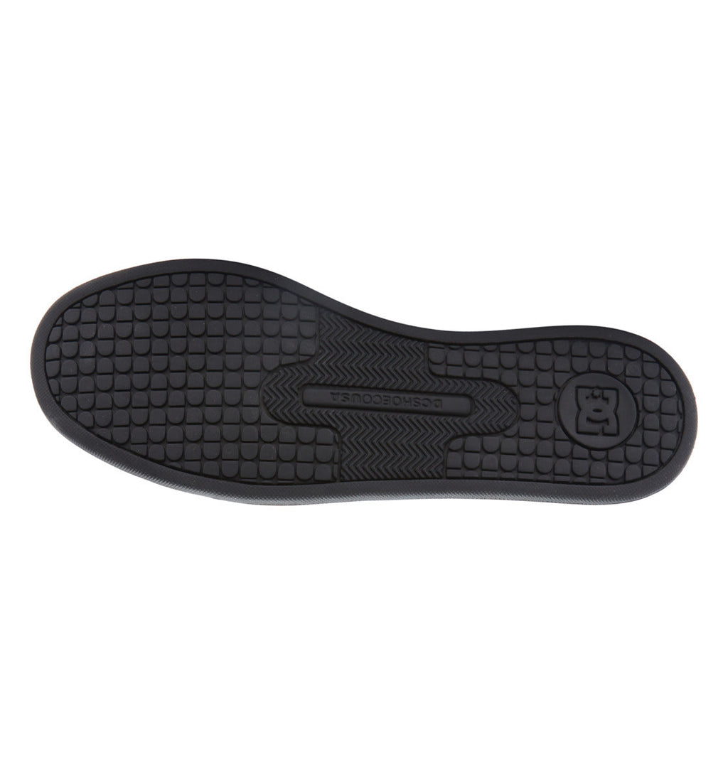 Crafted for the Women’s Court Graffik Shoes by DC Shoes, this black rubber sole features a textured grip pattern with both circular and grid-like tread designs for enhanced traction. The DC Shoes logo and text are prominently displayed at the heel and center, complementing the chunky ’90s-inspired sneaker style.