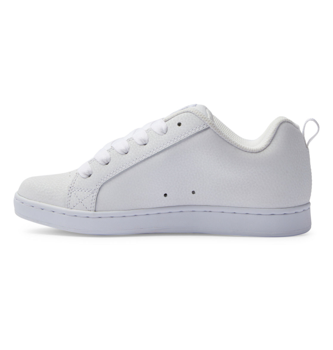 A side view of the DC Shoes Women’s Court Graffik Shoes features a plain white low-top design with white laces, a textured surface, and a white rubber sole. This sleek sneaker channels ‘90s style with a modern twist on the classic chunky silhouette.