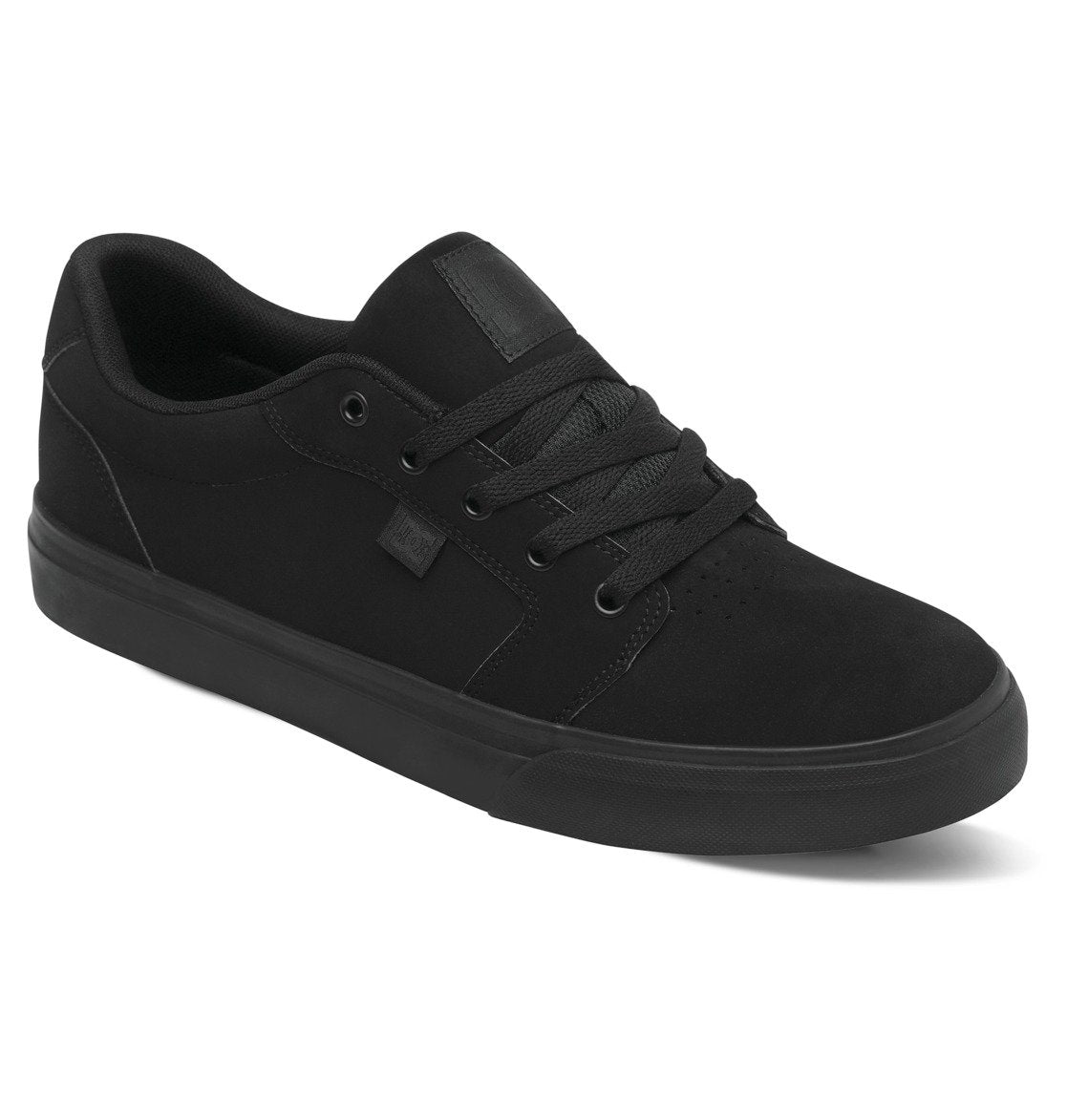The Men’s Anvil Shoes by DC Shoes are black low-top sneakers with black laces and a flat sole, displayed at an angle on a white background. These skate-inspired shoes provide all-day comfort.