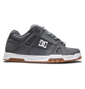 Introducing the Men’s Stag Shoes by DC Shoes: these sneakers feature a sleek gray upper with a white sole and brown tread, highlighted by the signature DC logo in white on the side. The design includes gray laces, black trim accents, and a durable cupsole crafted for long-lasting wear.
