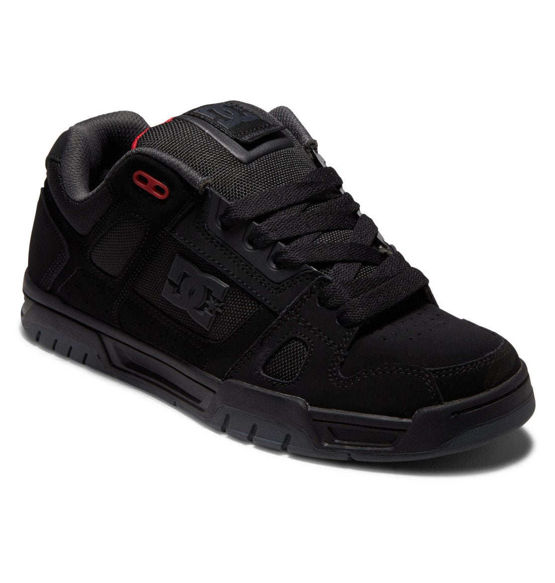 The DC Shoes Men’s Stag Shoes feature a sleek black design with durable cupsole construction, mesh and suede detailing, black laces, and subtle red accents near the top eyelets for a technically-inspired look.