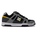 Introducing the Men’s Stag Shoes by DC Shoes: a black and gray skate shoe with striking yellow accents and a white sole, highlighted by the iconic DC logo on the side. Designed for comfort with an oversized puff tongue and built to last with a durable cupsole.