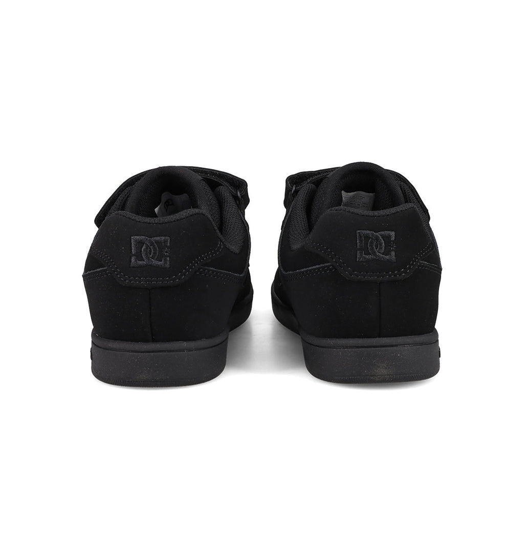 A pair of Kids’ Manteca 4 V Shoes by DC Shoes in black, seen from the back to showcase the heels and signature logo on each shoe. Made with durable suede, these kid-friendly sneakers are positioned side by side on a white background.