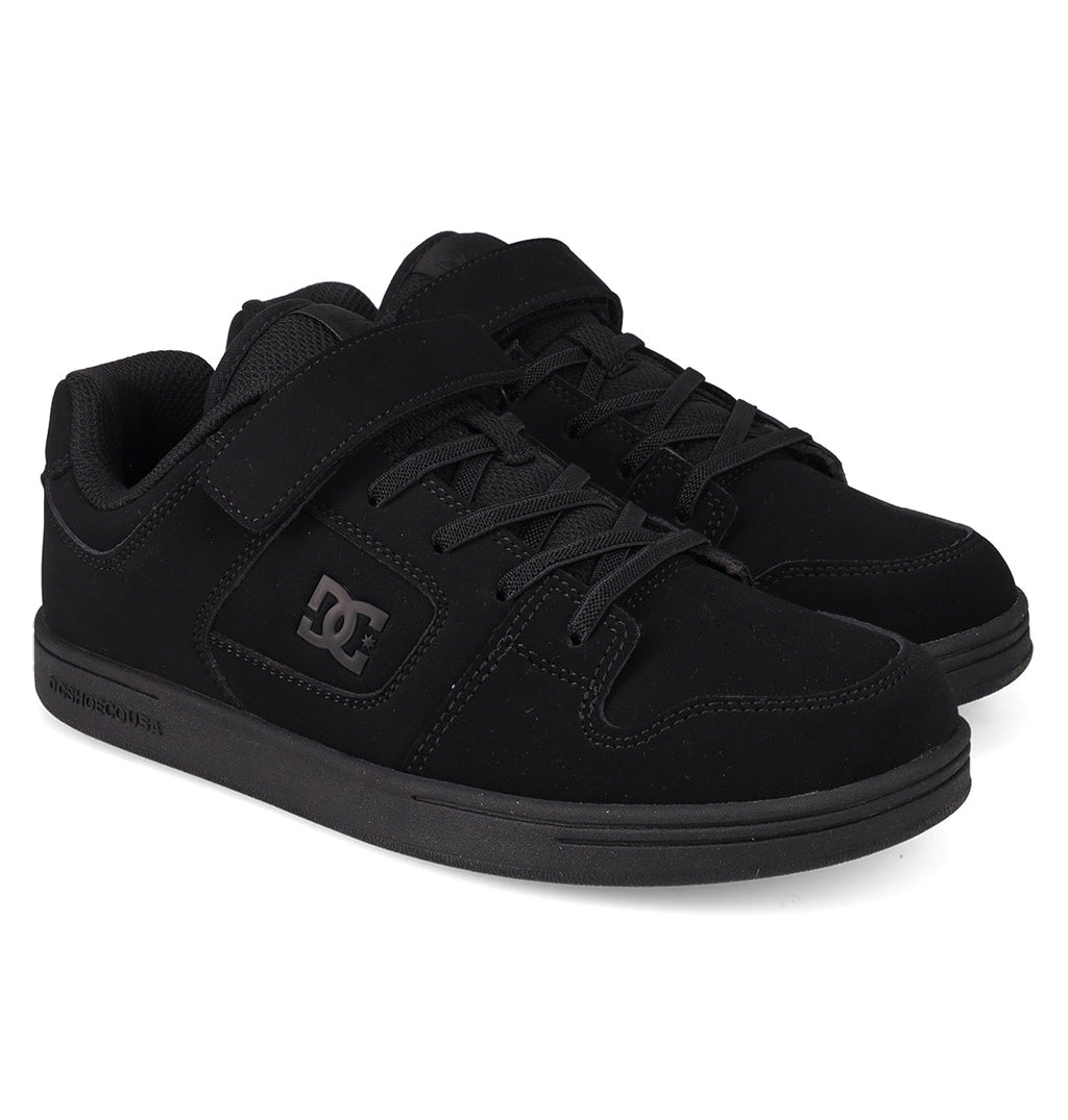 A pair of DC Shoes Kids’ Manteca 4 V Shoes in black, featuring laces and a Velcro strap for easy fastening, the signature DC logo on the side, and a thick rubber sole. Constructed from durable suede, these kid-friendly sneakers are ideal for active days on the go.