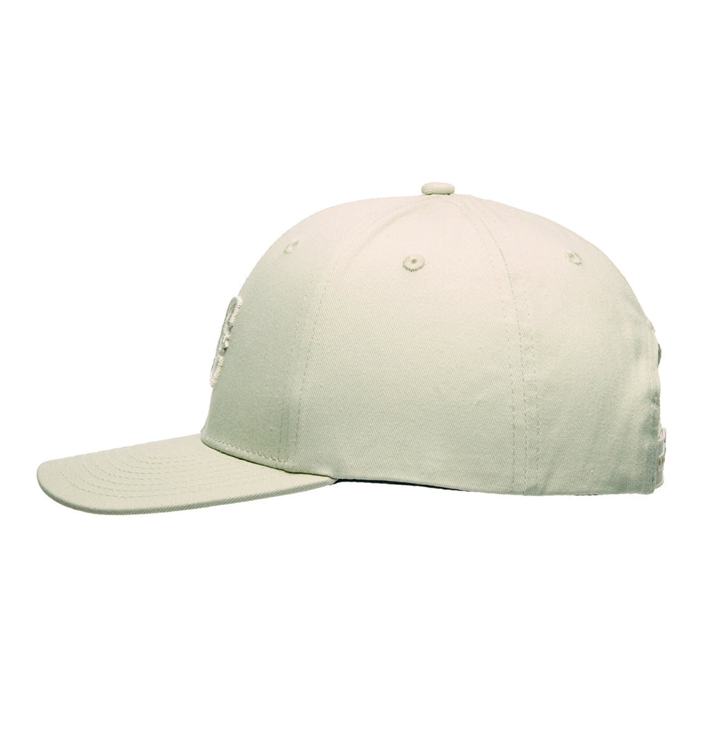 The DC Shoes Legacy Star Snapback is a plain light beige twill cap, displayed from the side, featuring a curved brim, visible panel stitching, and classic snapback styling.