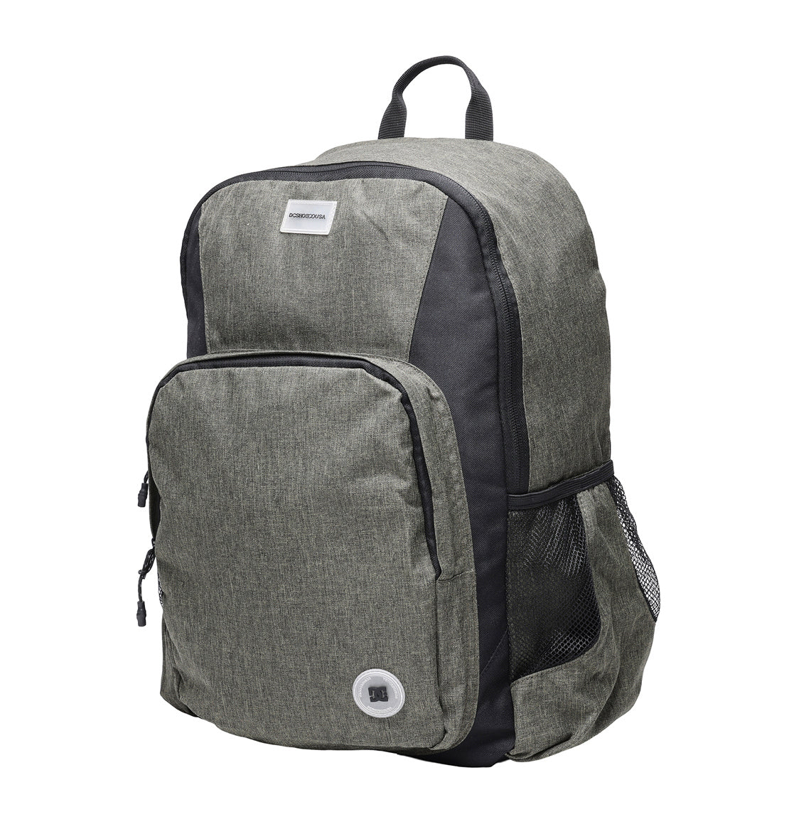 The DC Shoes Locker Backpack in gray and black features a spacious 23L capacity, large front pocket, side mesh pocket, small top handle, padded laptop sleeve, and a headphone port. The bag is displayed standing upright on a white background.