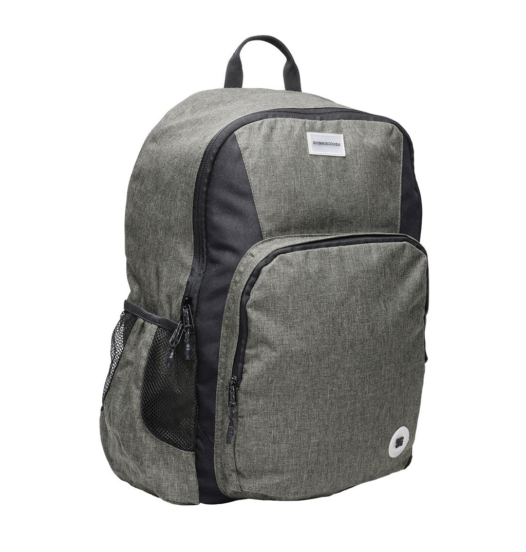 A gray and black DC Shoes Locker Backpack featuring a front zipper pocket, mesh side pocket, top handle, padded laptop sleeve, and a small rectangular label near the top.