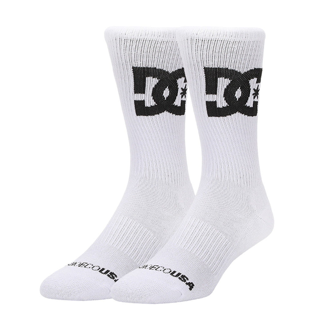 A 3-pack of DC Shoes Big Star Logo crew socks in white, each featuring a bold black DC logo on the sides and "DC SHOES USA" text on the toes, displayed upright against a plain white background.