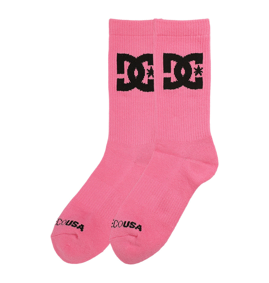 A pair of pink crew socks from the DC Shoes Big Star Logo Crew Socks 3-Pack, featuring a bold black DC Shoes logo on the sides and black DC USA text near the toes.