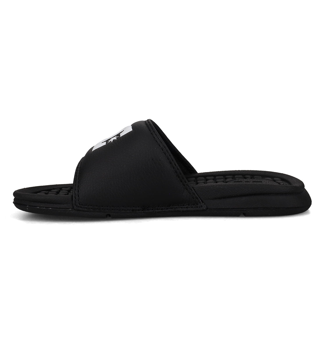 The Kids' Bolsa Slides by DC Shoes are black sandals featuring a thick strap and textured footbed, displayed in side profile against a white background—ideal for kids who want comfortable slides.
