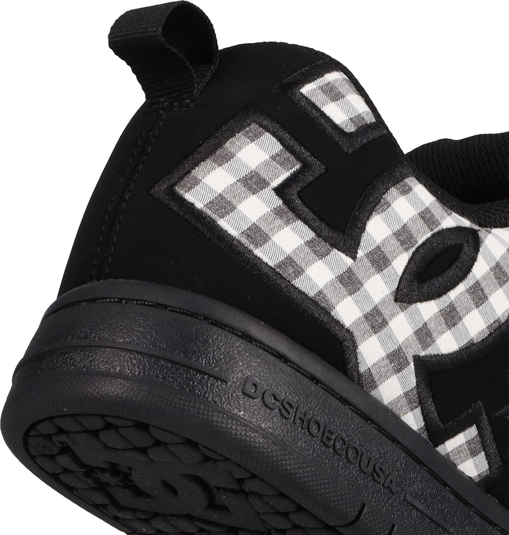 Close-up of the heel and side of men's Court Graffik shoes by DC Shoes, showing the puffy silhouette, bold DC logo lettering, DCSHOECOUSA embossed on the sole, and a black-and-white checkered pattern for a signature look.
