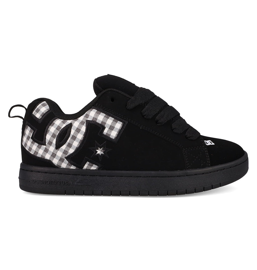 The Men's Court Graffik Shoes by DC Shoes feature a classic puffy black silhouette, thick sole, black laces, and a bold black-and-white plaid DC logo with a subtle star detail on the side.