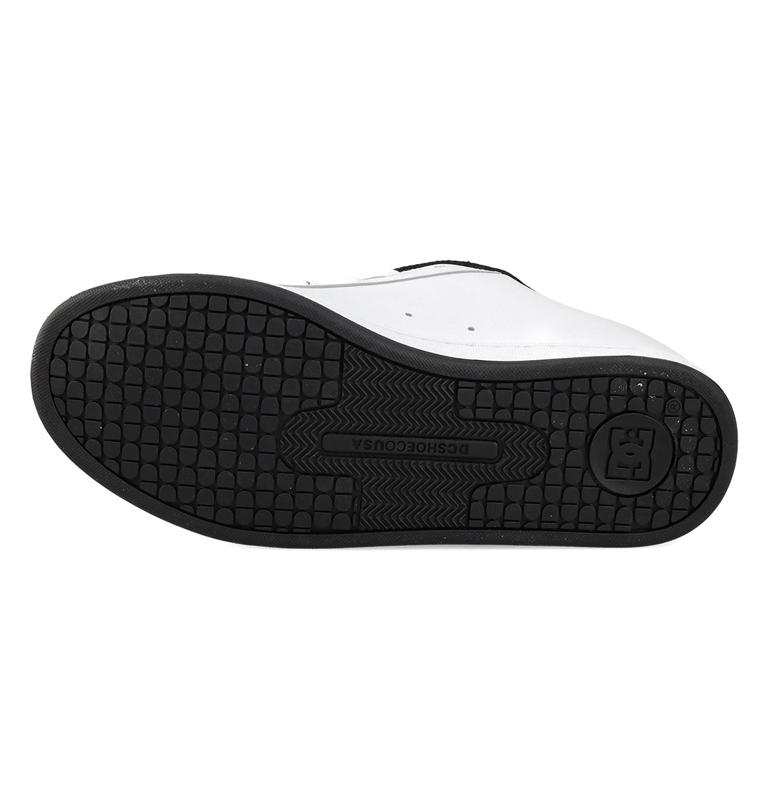 The image displays the black rubber sole of the Women’s Court Graffik Shoes by DC Shoes, featuring a textured grip pattern with the iconic DC Shoes logo at the center. This classic design captures bold ’90s style, delivering reliable traction and standout aesthetics for women’s sneakers.