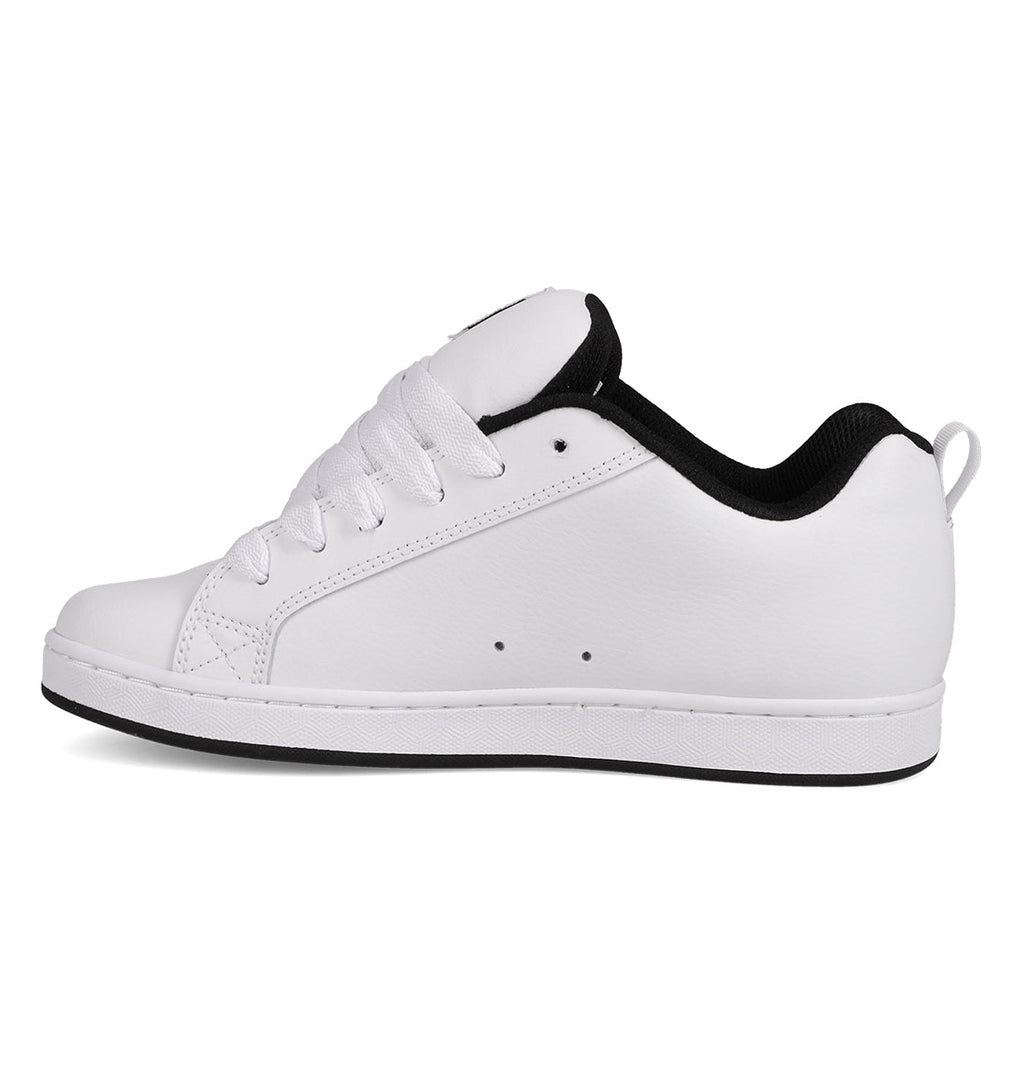 A side-profile image features the Women’s Court Graffik Shoes by DC Shoes—a white, low-top sneaker for women with white laces and a black inner lining. Shown on a plain white background, this design channels chunky ’90s-inspired style for a retro look.