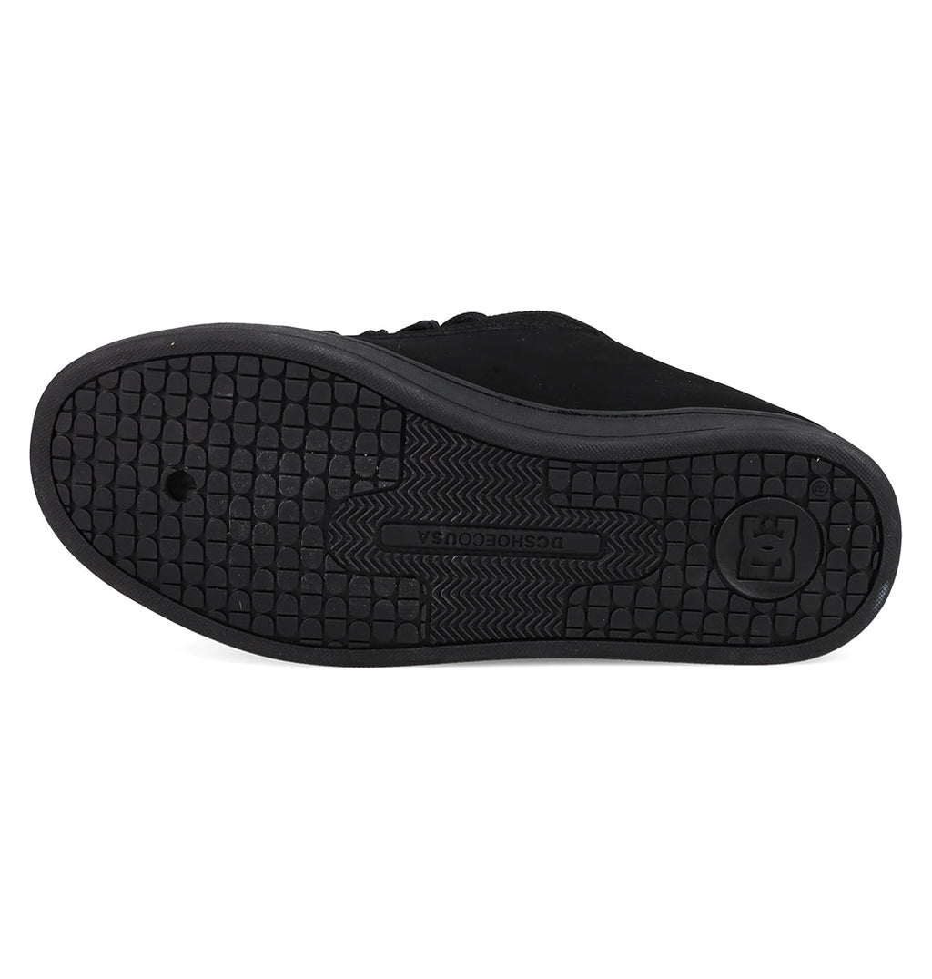 The sole of a black Women's Court Graffik Shoe by DC Shoes features a textured grid pattern for grip, with the DC logo and DCSHOECOUSA embossed in the center.