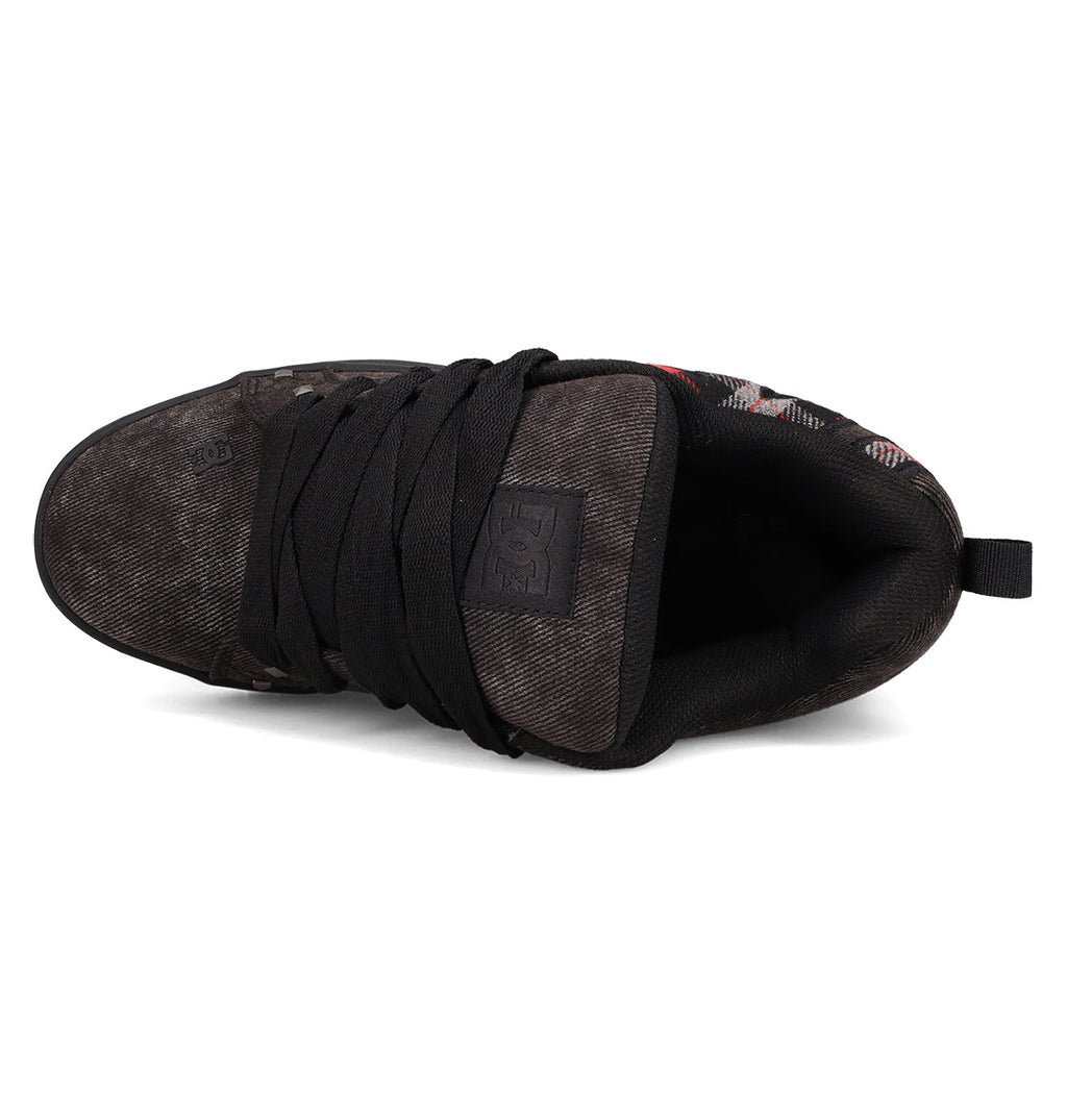 Top view of DC Shoes Men's Court Graffik SE Shoes in black, featuring a puffy silhouette, thick black laces, padded tongue with DC logo, and a worn textured finish on the premium material upper at the toe and sides.