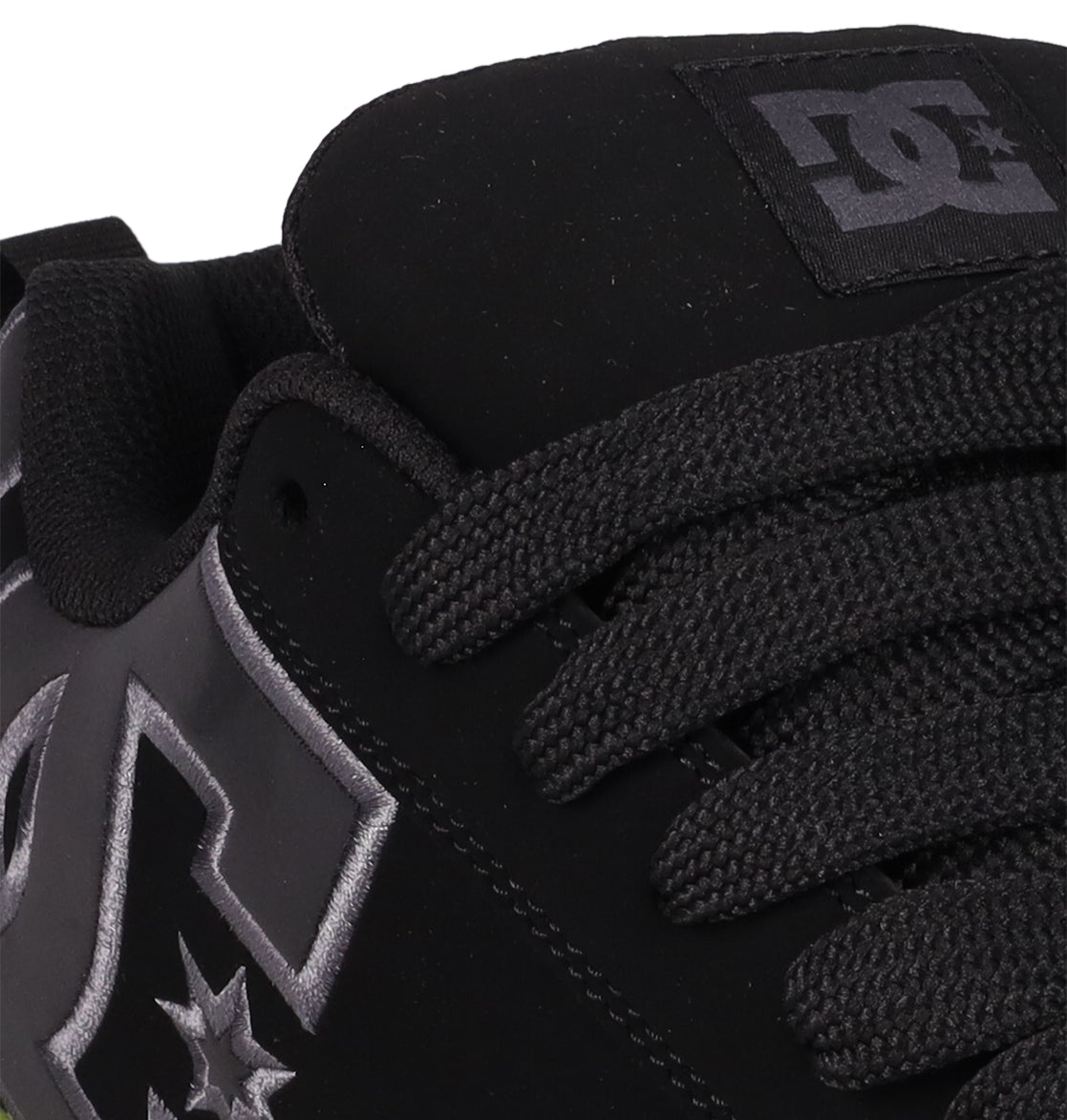 Close-up of the DC Shoes Men's Court Graffik SE—a black skate shoe with a puffy silhouette, thick black laces, and the DC logo in white and gray on the side and tongue.