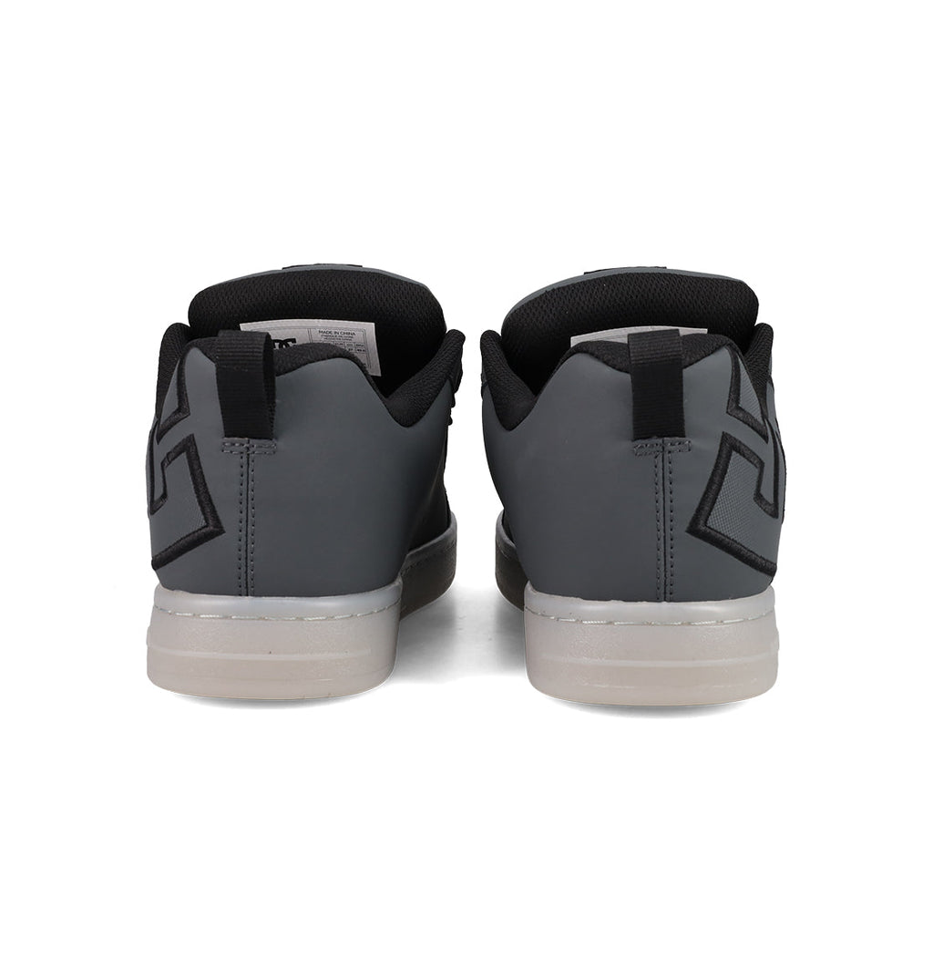 The Men's Court Graffik SE Shoes by DC Shoes feature a puffy silhouette, premium upper materials, gray color with white soles, black geometric heel designs, and black inner lining for an elevated look.