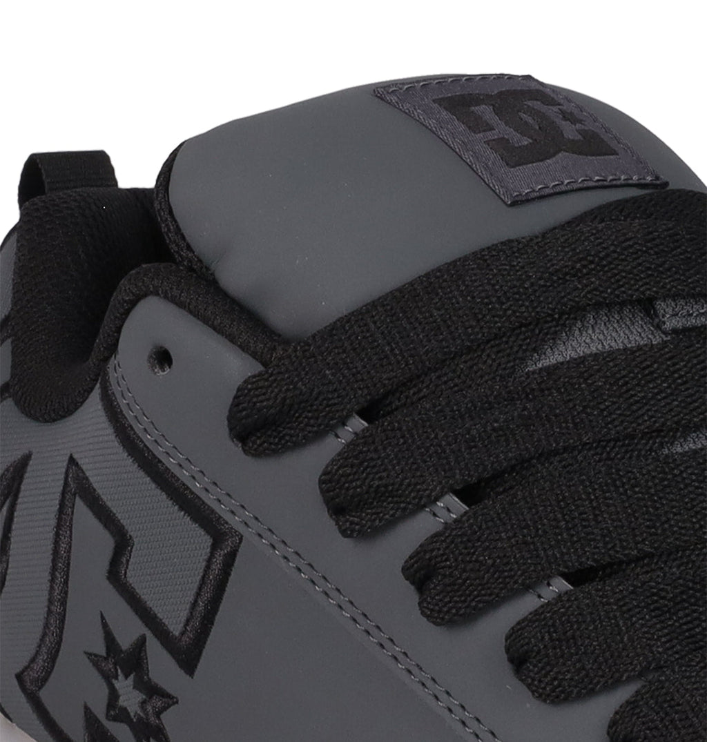 Close-up of the DC Shoes Men's Court Graffik SE sneaker in gray with black laces, a visible logo on the side and tongue, premium uppers, black trim, and a puffy silhouette for an on-trend style.