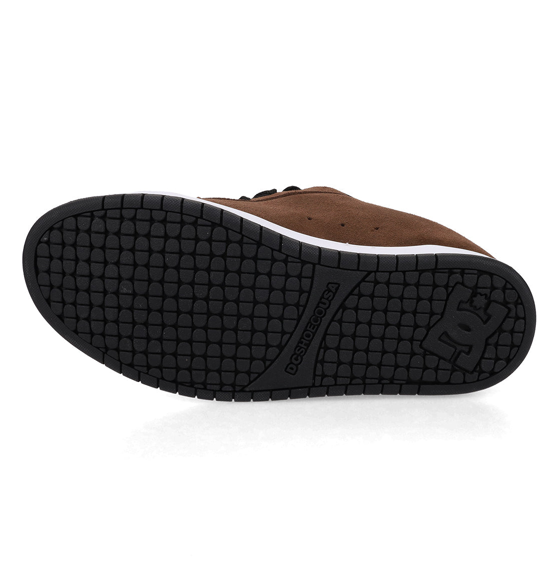 A brown DC Shoes Men’s Court Graffik Special Edition Shoe viewed from below, featuring a textured black rubber sole with the DC logo and “DCSHOECOUSA” embossed near the heel, characteristic of the Court Graffik’s signature puffy silhouette.