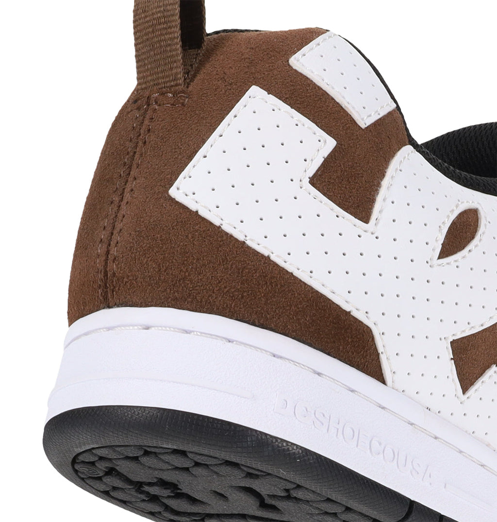 Close-up of the Men’s Court Graffik Special Edition shoe by DC Shoes, featuring a brown suede upper, perforated white DC logo detail on the heel, visible stitching, a white midsole, black outsole, and a brown pull tab—highlighting the signature puffy silhouette of the Court Graffik.