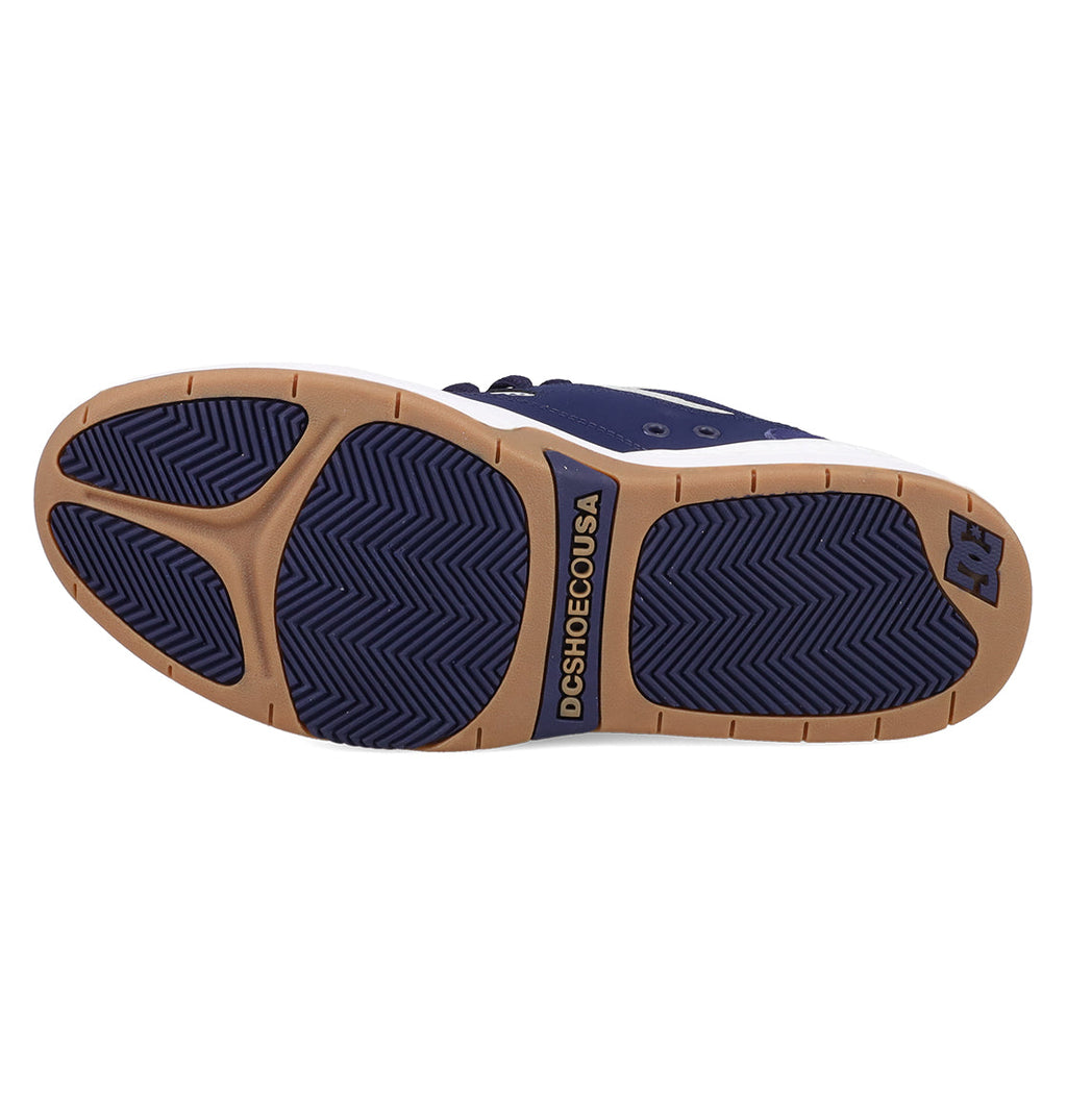 The image shows the sole of the Men's DC Ascend S Shoes by DC Shoes. The tan sole has navy blue rubber grips, a herringbone tread, and "DCSHOECOUSA" plus the DC Shoes logo in navy near the arch and heel.