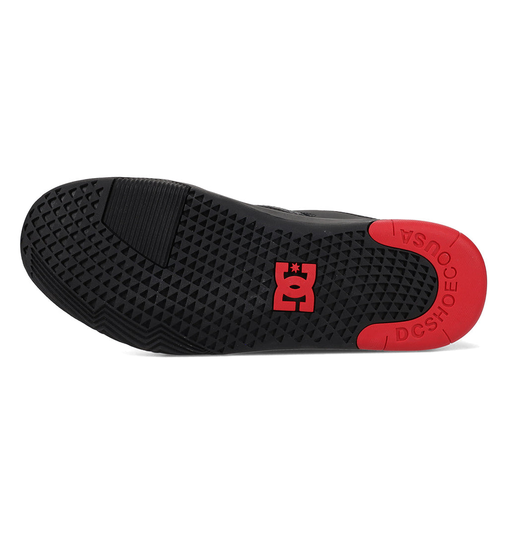 The men’s Metric shoe by DC Shoes has a black sole with a patterned grip and features black, grey, and red accents on the heel and toe. The center displays the DC logo in red, while “DCSHOECO USA” is printed along the heel.