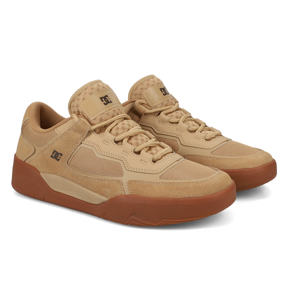A pair of Men’s Metric Skate Shoes by DC Shoes, featuring a tan colorway with gum soles, mesh and suede accents, a durable outsole for lasting wear, and the DC logo on the side and tongue.