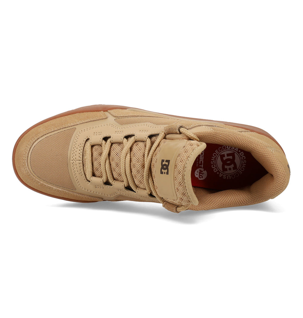 Men’s Metric Skate Shoes by DC Shoes in tan feature a gum sole, mesh and leather upper, laces, and a velcro strap. Shown from above, these skate shoes are built with a durable outsole for long-lasting wear. The insole displays a red circular DC Shoes logo near the heel for signature flair.