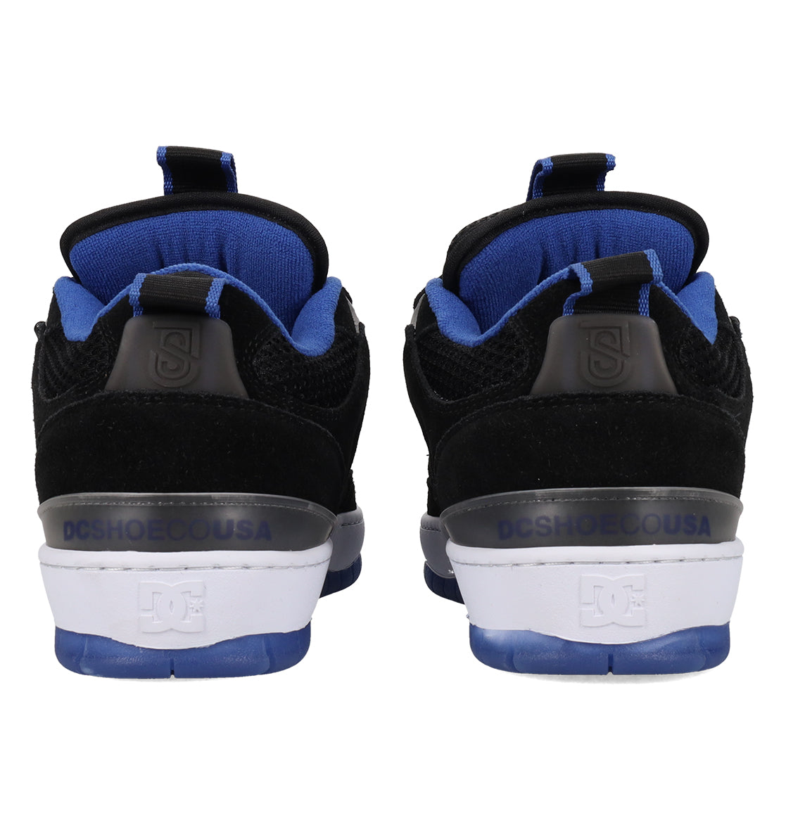 Rear view of a pair of Men’s JS-1 Shanahan Pro Skate Shoes by DC Shoes in black and blue, featuring a suede upper, white midsoles, blue outsoles with the signature DC Pill Pattern Outsole, and “DCSHOECOUSA” text on the back heels.