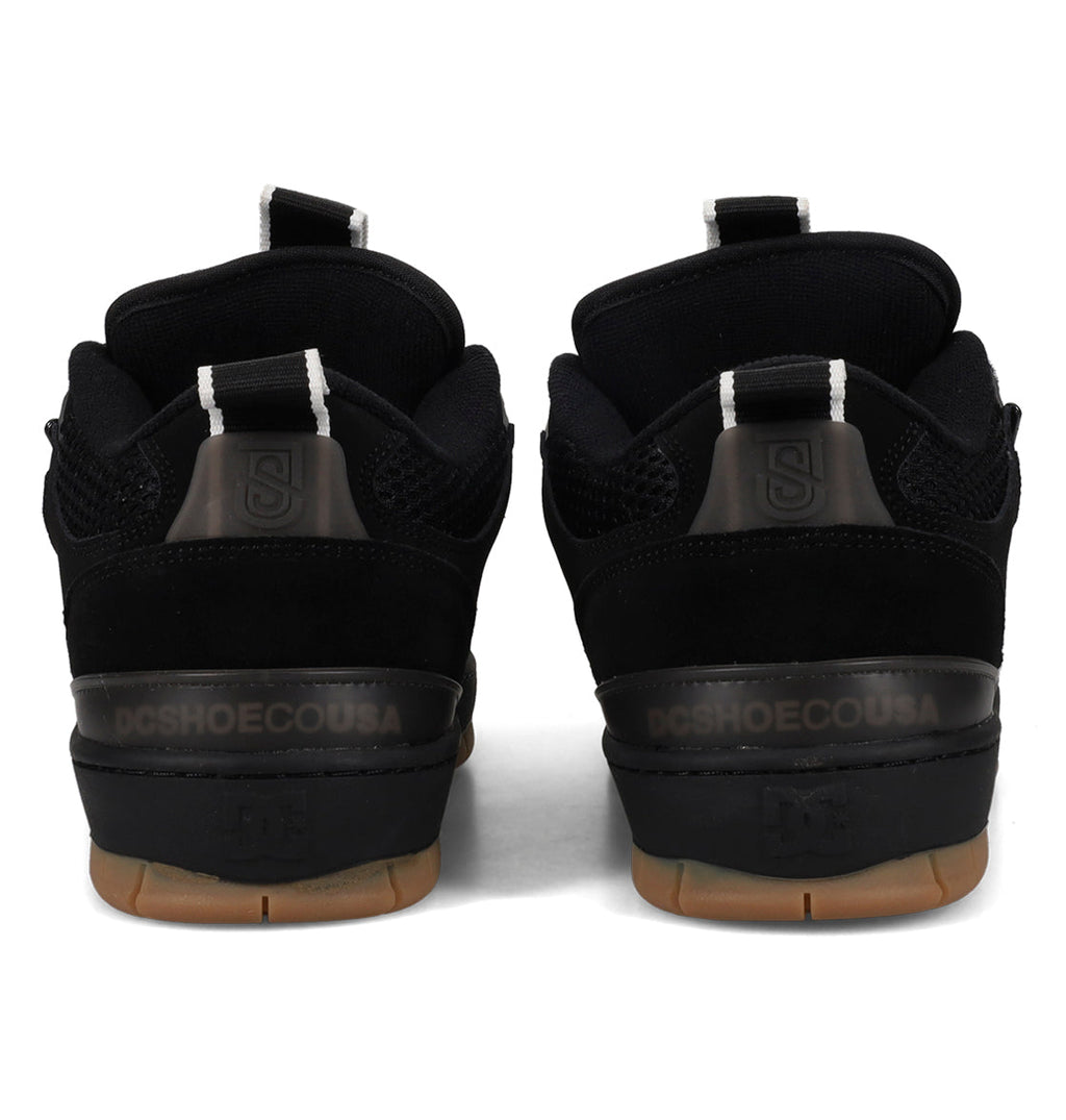 Black athletic shoes with visible brand logo on a white background