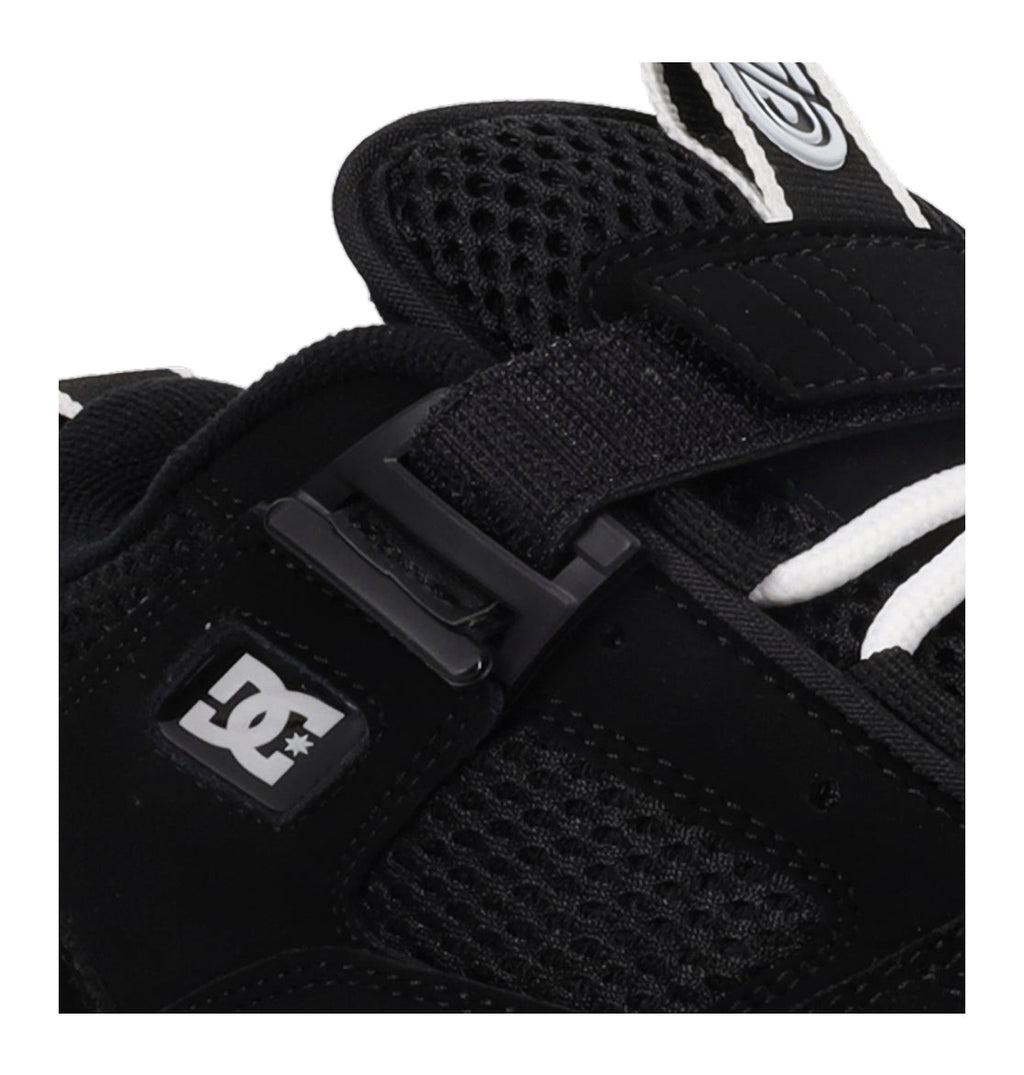 Close-up of a black glove with a buckle and DC logo on a white background