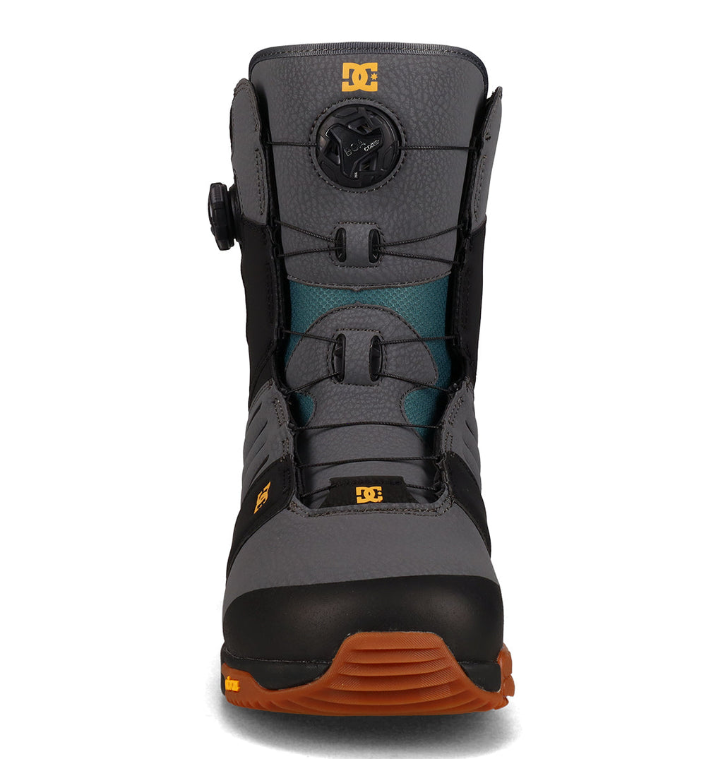 Front view of the DC Shoes Men’s Judge Snowboard Boots in gray and black, featuring a brown sole, teal tongue detail, and a circular tightening knob on the upper front—ideal for riders seeking reliable snowboarding boots that combine style and performance.