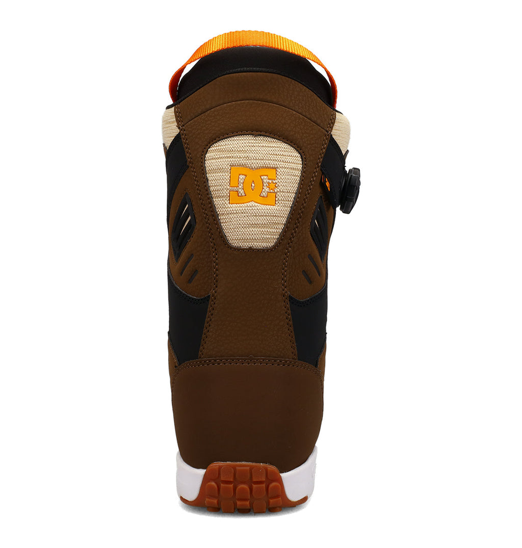 A rear view of the DC Shoes Men’s Judge Snowboard Boots in brown, black, and beige, showcasing an orange pull tab and a white outsole designed for durable performance and advanced support on the slopes.