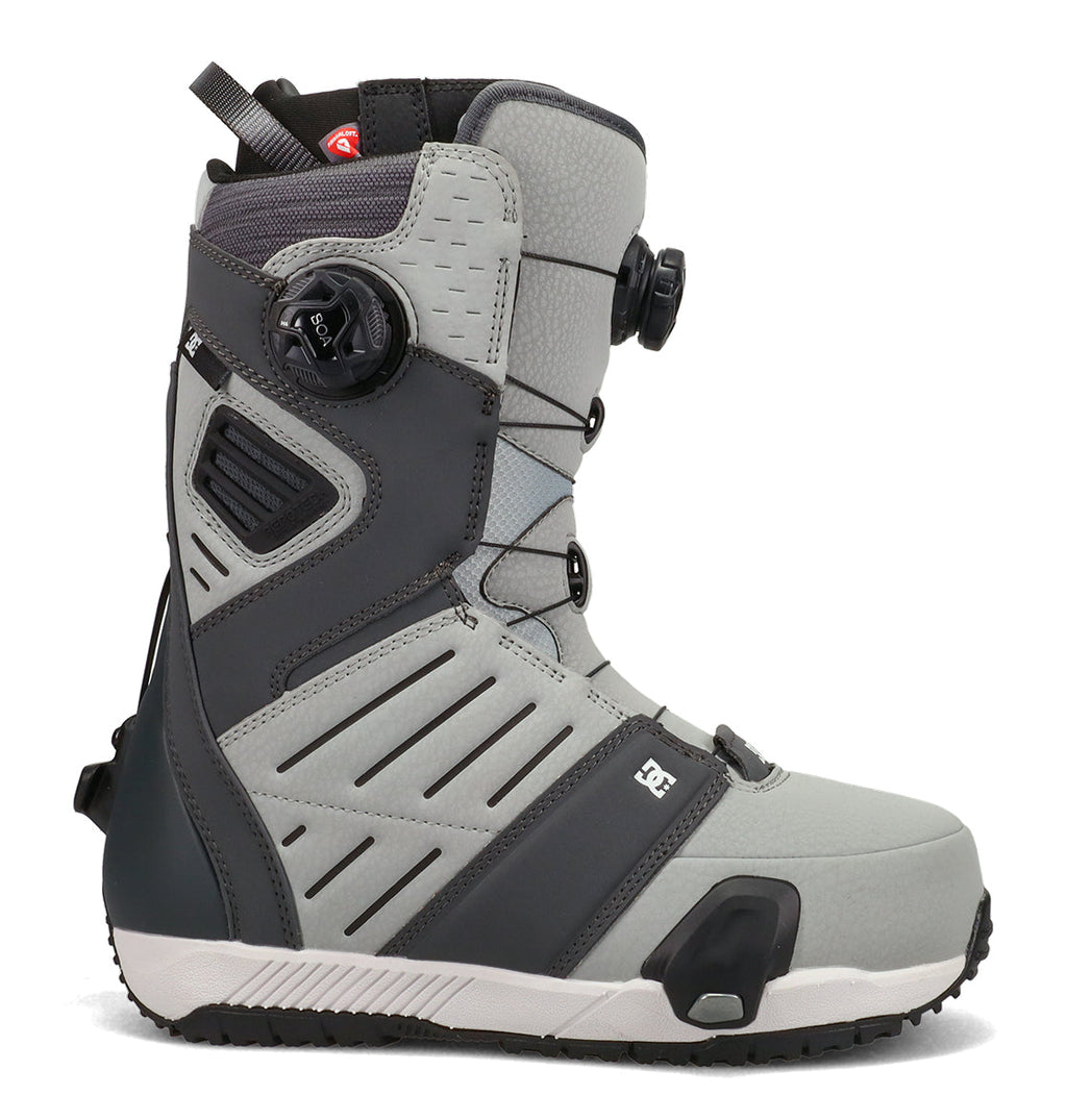 A side view of the Men’s Judge Step On® Snowboard Boots by DC Shoes is displayed on a white background, featuring gray and black colors, the BOA Fit System for lacing, a reinforced toe, a textured sole, and the DC logo near the front.