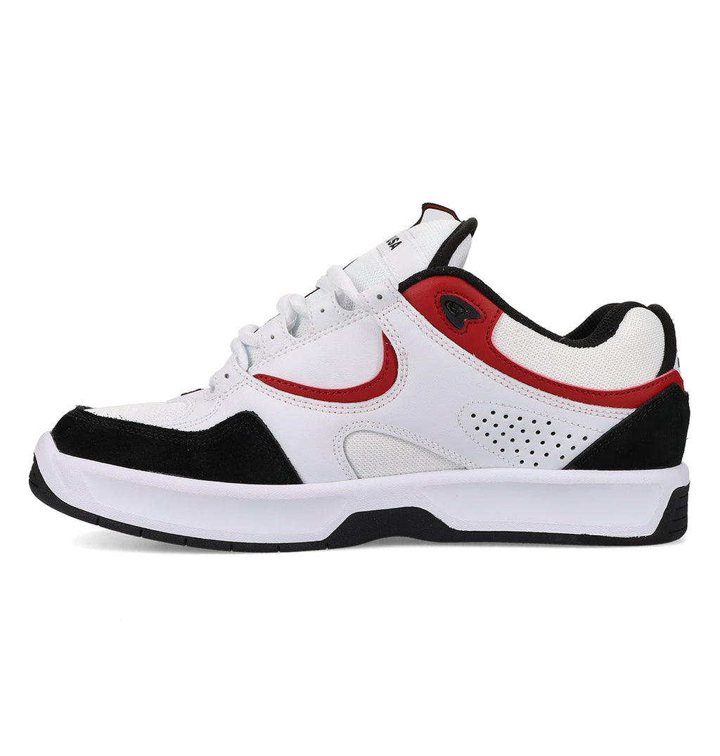 A classic skate shoe from DC Shoes, the Men’s Kalynx Zero features a white upper with black and red accents, a black outsole, white laces, and a perforated side panel—displayed from the left side on a plain white background.