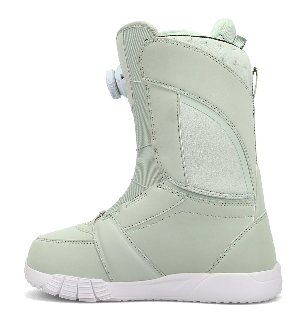 The DC Shoes Women’s Lotus Snowboard Boots are shown in a left-facing side profile on a white background. This light gray boot features a white sole, an easy-to-use side dial for adjustable tightening and enhanced support, and reinforced heel and toe areas for added comfort.