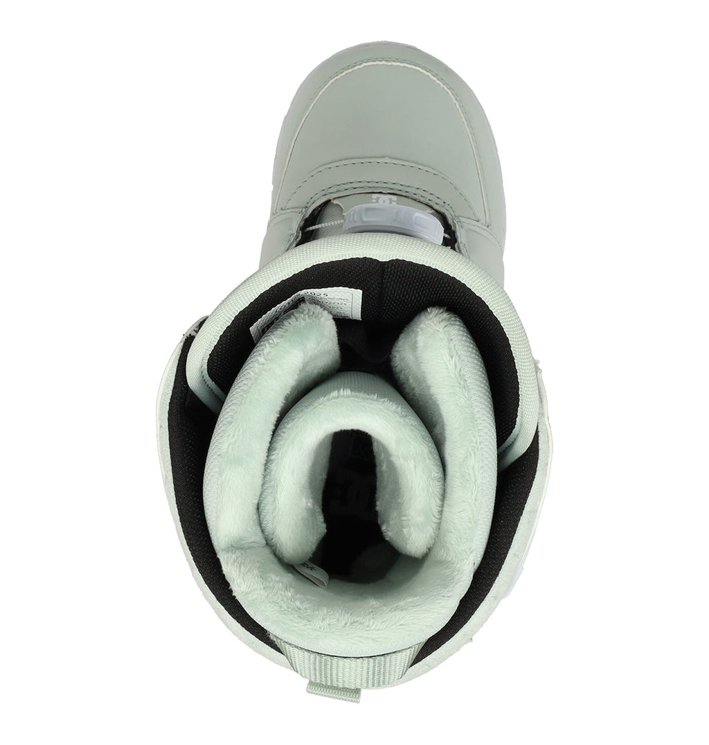 Top view of a single Women’s Lotus Snowboard Boot by DC Shoes in light green, featuring a soft, plush inner lining and black accents. The boot looks sturdy, providing excellent support and comfort with thick insulation visible around the ankle and inside the opening.