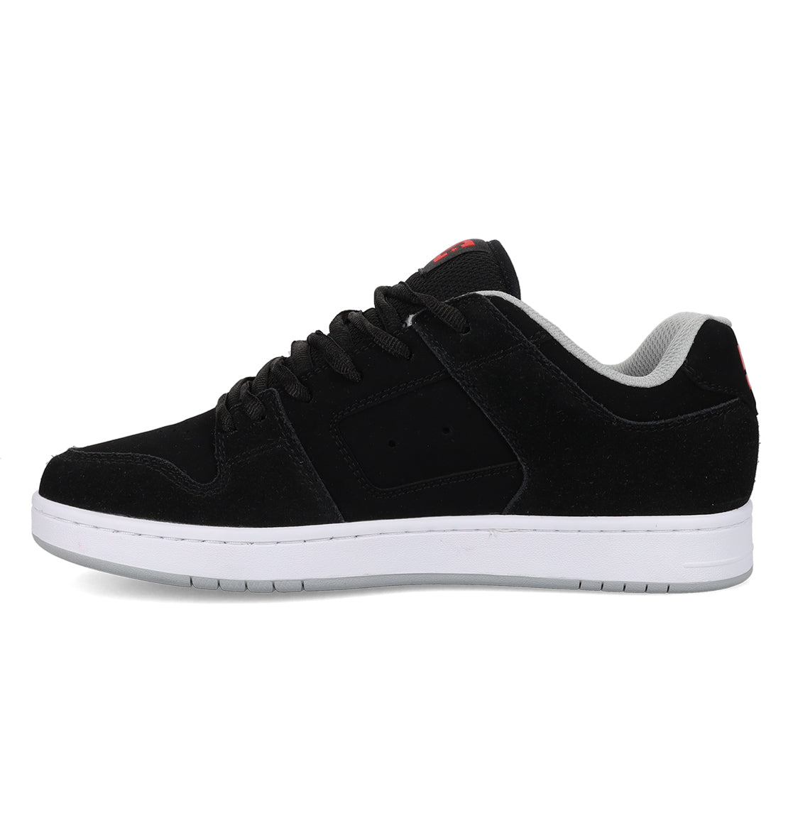 A side view of the DC Shoes Men’s Manteca 4 Shoes is displayed against a white background, showcasing their black low-top design with a white sole, black laces, and gray inner lining. Blending classic style with modern comfort, this model is recognized as one of DC Shoes’ leading performance skate shoes.