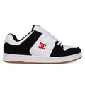 A black and white DC Shoes Men's Manteca 4 with a gum sole, white laces, red DC logo on side and tongue, plus suede accents. This low-cut sneaker offers classic style for skate or streetwear.