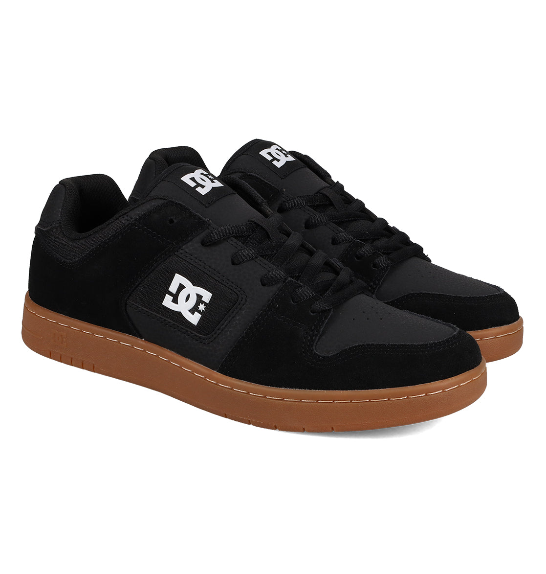 A pair of Men’s Manteca 4 Shoes by DC Shoes, featuring a black upper with gum soles, black laces, and signature white DC logos on the side and tongue, presented at an angle on a white background to showcase their classic style and modern comfort.
