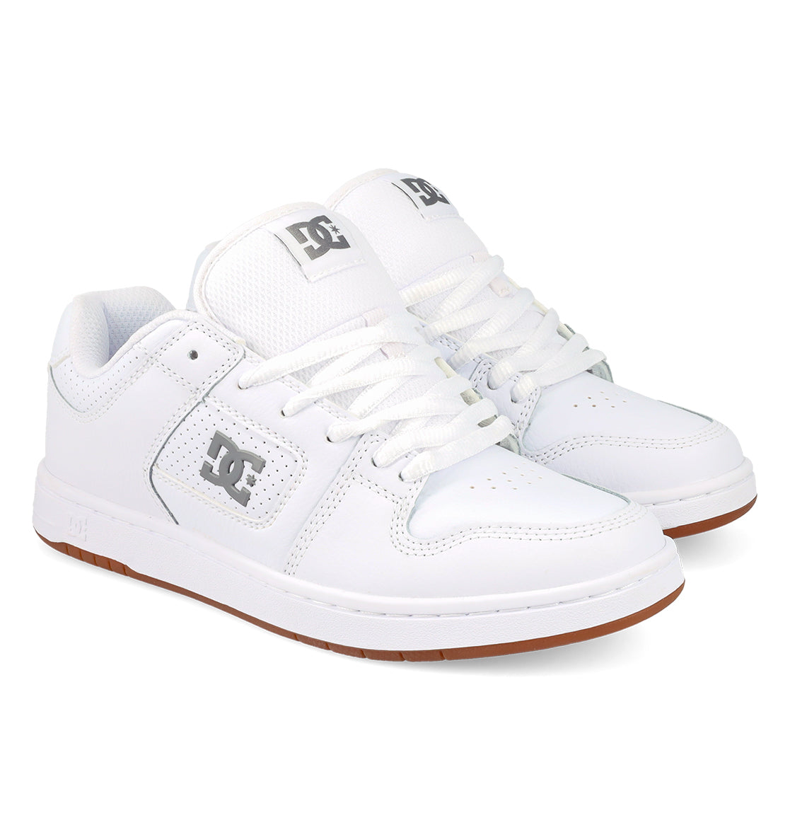 A pair of DC Shoes Women’s Manteca 4 Shoes, featuring a white colorway with white laces, grey DC logos on the side and tongue, and brown rubber soles—highlighting their performance-focused design—are displayed against a white background.
